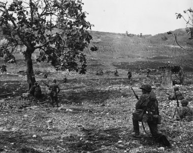 Marines battle Japs across an open field on Saipan. The te…