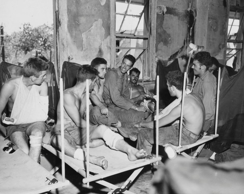 Navy Chaplain Edward Brubaker (center) of Cadillac, Mich.,…