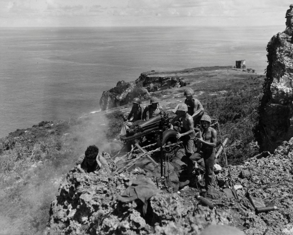 Tinian, August 25, 1944: Marines manning a field howitzer …