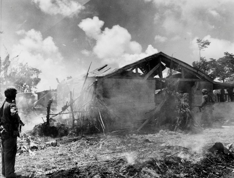 Smoke nearly obscures Marines in the background as they pu…