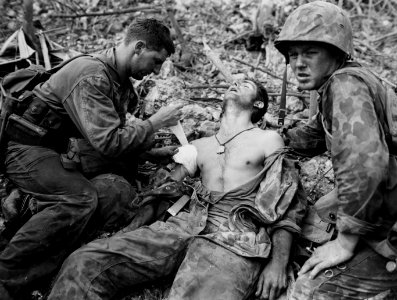 Wounded Marine gets first aid right on the front line duri… photo
