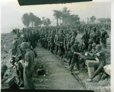 American MPs tabulating droves of Nazi prisoners near St. …