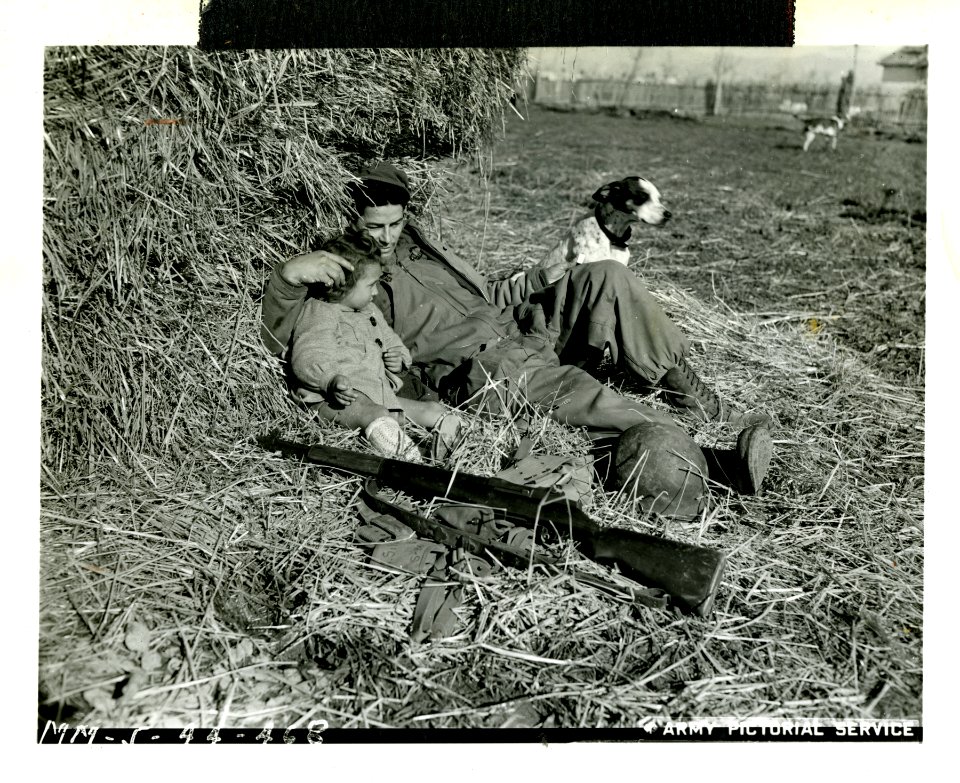 American soldier rests with an Italian child and dog, Acci…