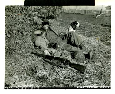 American soldier rests with an Italian child and dog, Acci…