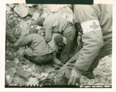 American soldier being pulled out from under debris after … photo