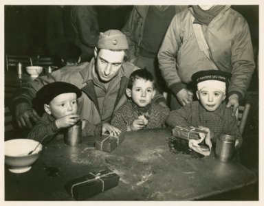 Pfc. Raymond Cyr, St. Albans, Vt., watches his 2 'adopted'…