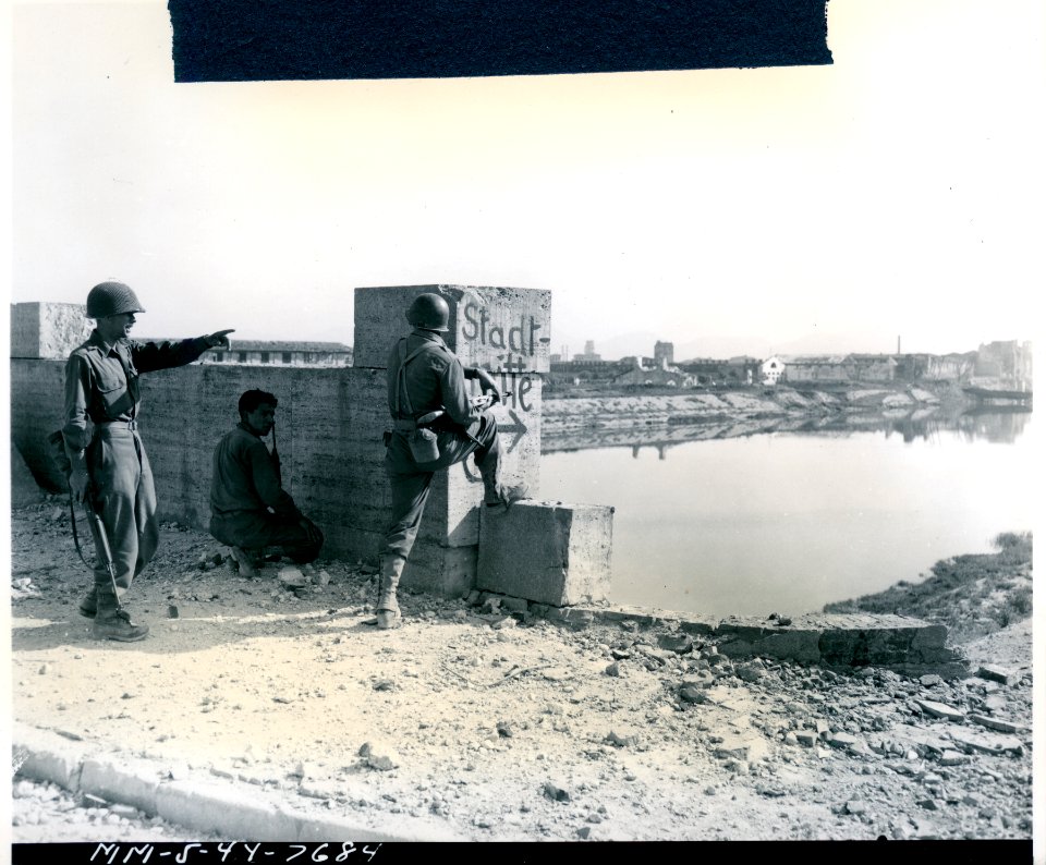 Three-man American patrol reconnoitering the Arno River, a…