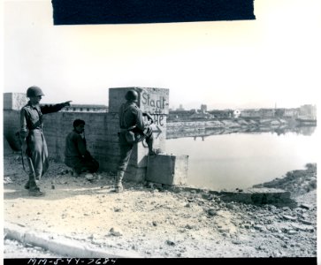 Three-man American patrol reconnoitering the Arno River, a… photo
