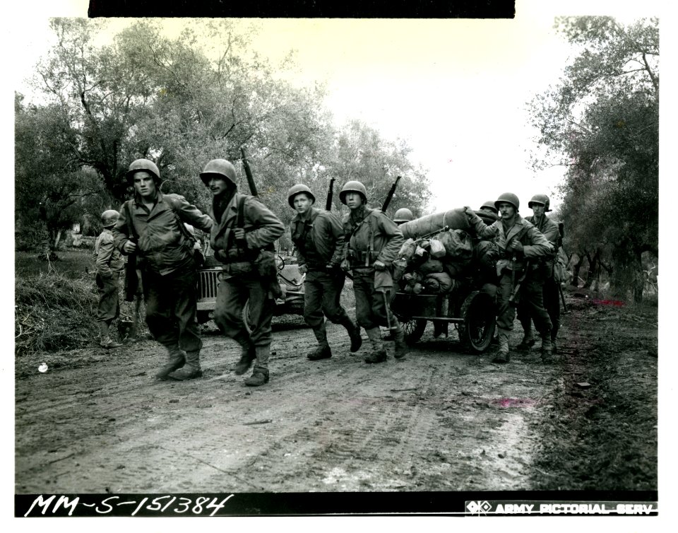 Mortar crew towing a cart loaded with their weapons, ammun…