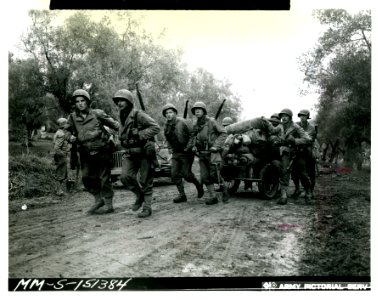 Mortar crew towing a cart loaded with their weapons, ammun…