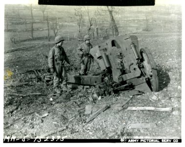 Two American soldiers examine the remains of this demolish…