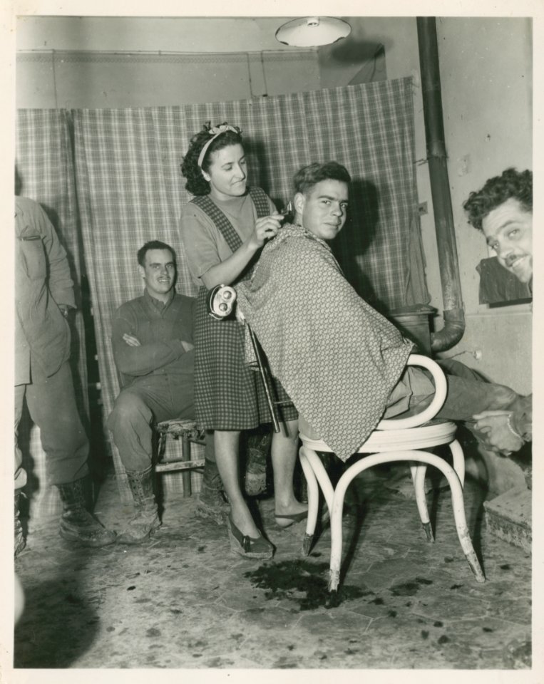 2nd Lt. Offa Cosey, Selma, 168th Infantry has his hair cut…