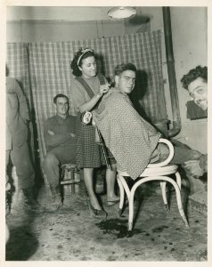 2nd Lt. Offa Cosey, Selma, 168th Infantry has his hair cut…