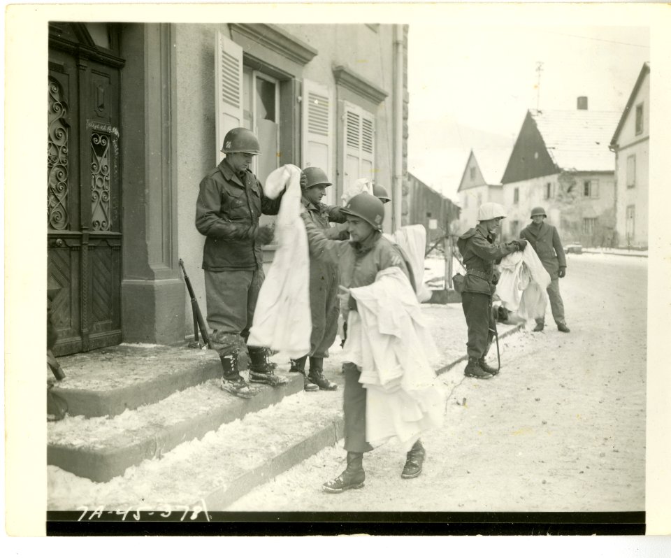 Officer in charge of battle patrol passes out the new snow…