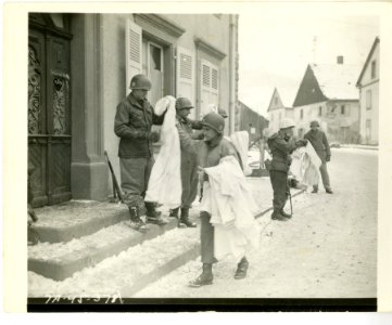 Officer in charge of battle patrol passes out the new snow…