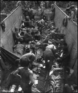 SC 180534 - Casualties shown lying on stretchers aboard li…