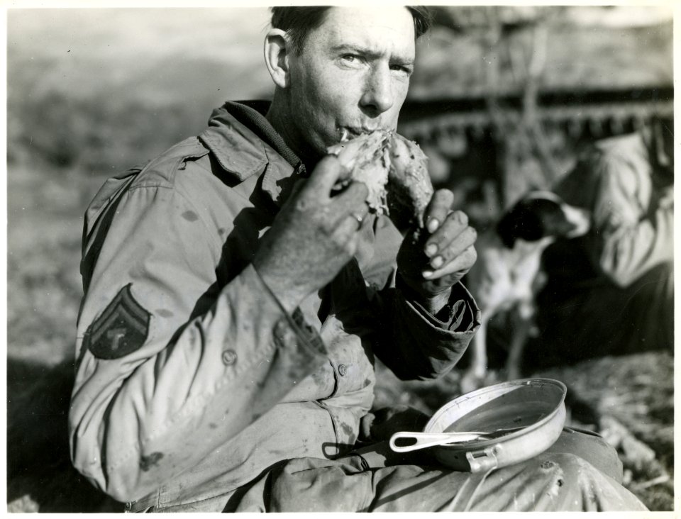 An American soldier eats a Thanksgiving turkey leg in San …