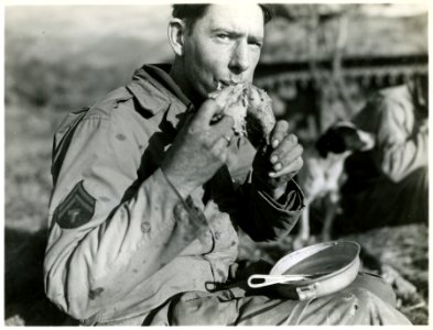 An American soldier eats a Thanksgiving turkey leg in San … photo