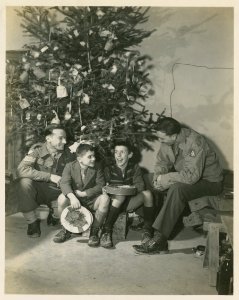 An American and a British soldier with two Italian boys un…
