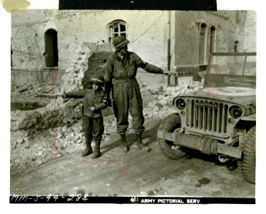 MP. Pvt. Mahlon Smith of Phoenixville, PA., is assisted in…