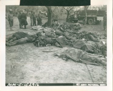 Dead German soldiers and their equipment at a collection p…