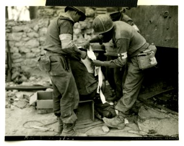 American infantryman gets back wound bandaged by medics af… photo