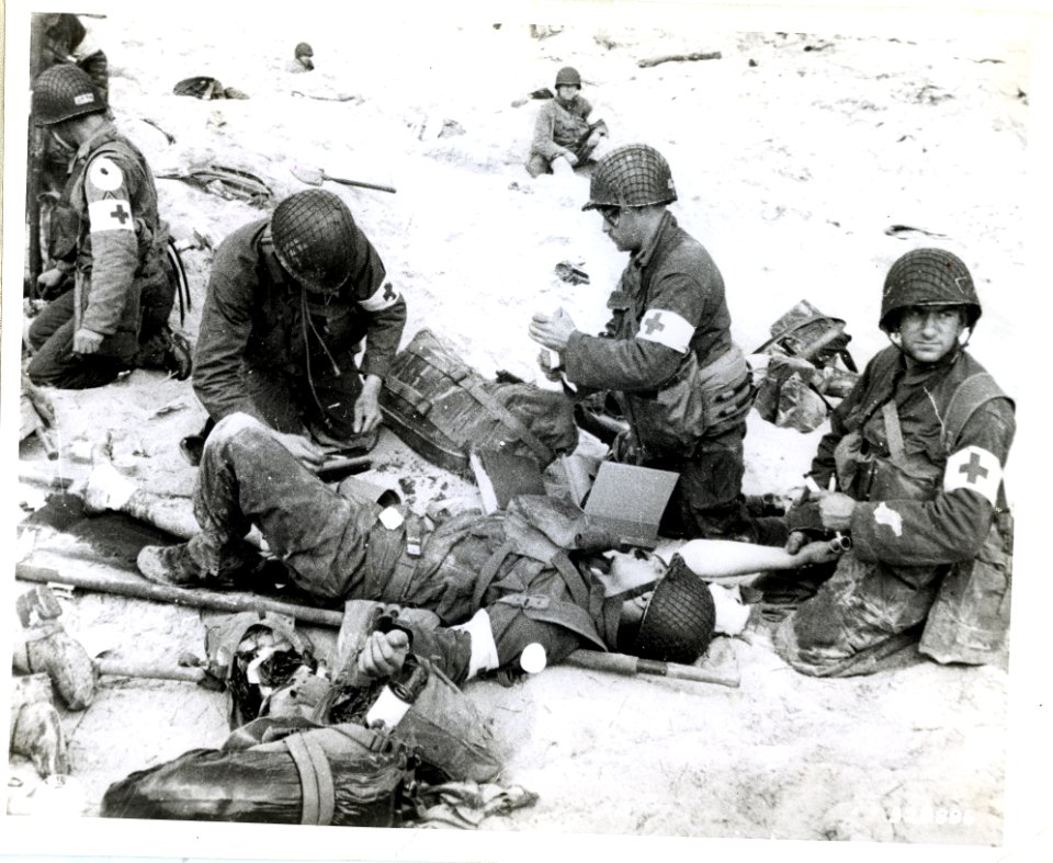SC 320886 - American Medics render first aid to troops in …