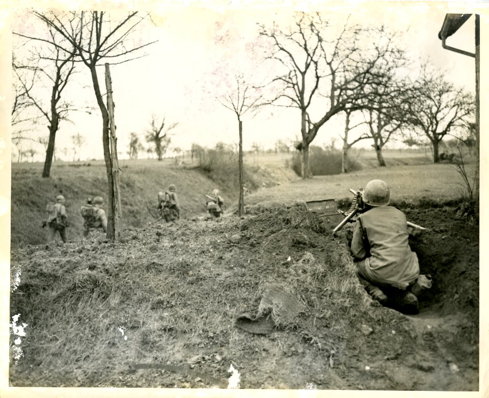 M2 machine gun provides cover for GIs of the 45th Infantry…