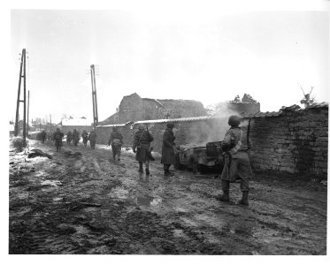 SC 198550 - Infantrymen move along a road through Beffe, B… photo