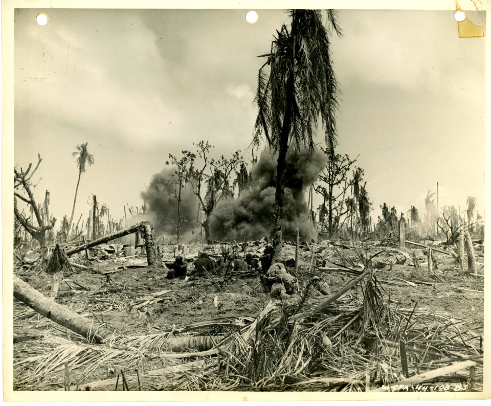 Men of 7th Div. are shown using a 27 lb. satchel charge of…