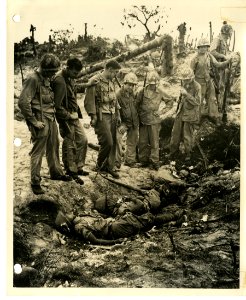 7th Division men looking down at dead Japanese soldiers in… photo