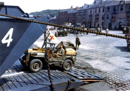 Jeeps being driven into the open doors of an L.C.T. at a p… photo