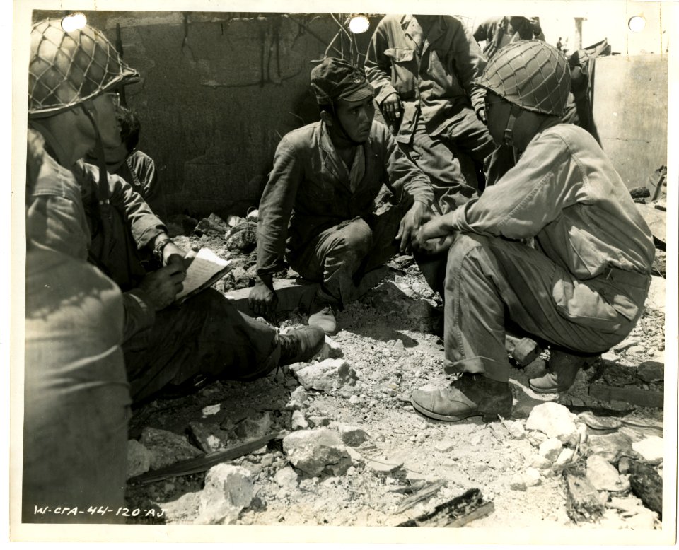 Maj. Beatty, left, S-2, 7th Div., with a translator, right…