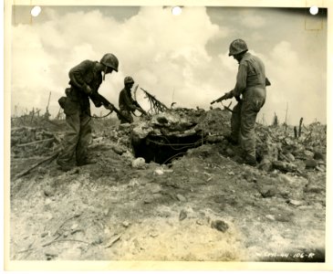 American Soldiers investigate Japanese bunker on Enubuj is… photo