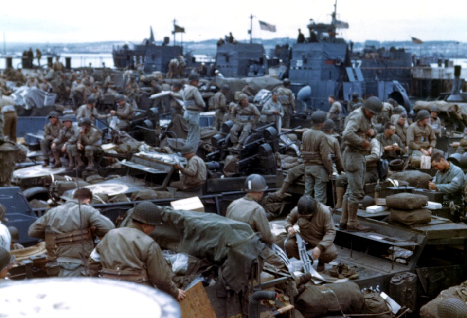 Men and equipment are massed together in landing craft in …