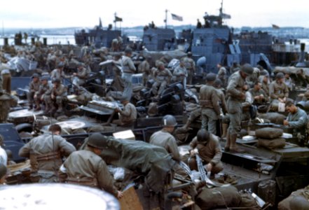 Men and equipment are massed together in landing craft in …
