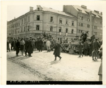 Civilians and liberated prisoners of war gathering around … photo