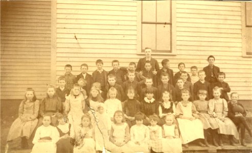 School Children and Teacher in Front of School photo