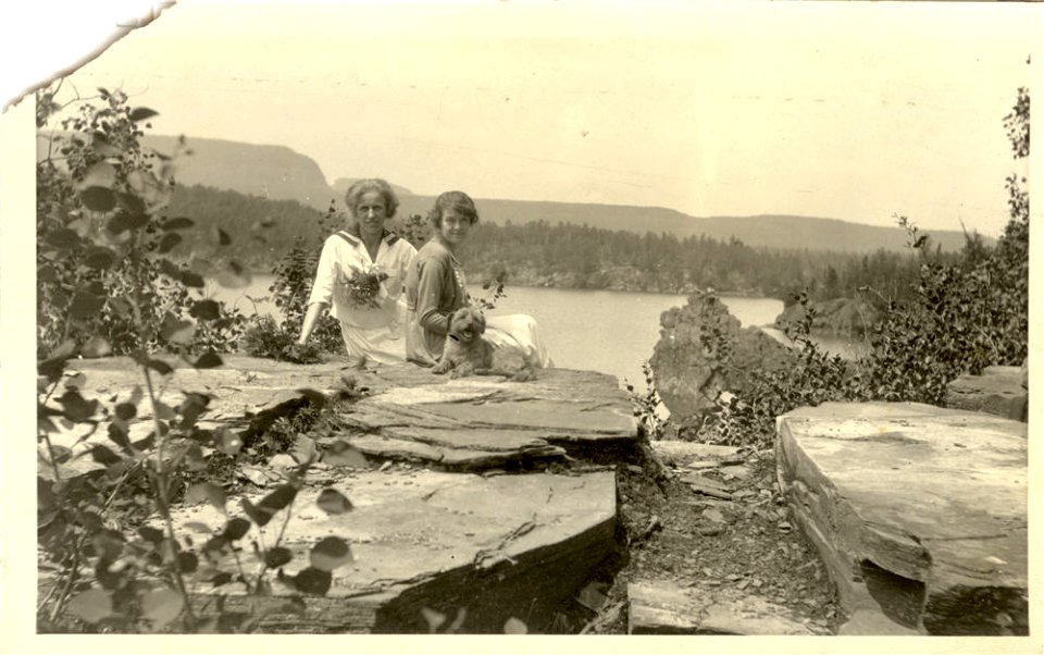 Two women sitting with dog