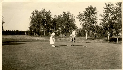 Man and Woman Golfing photo