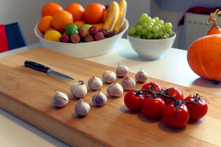 Cutting board tomatoes garlic photo