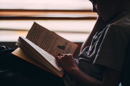 Boy reading book photo