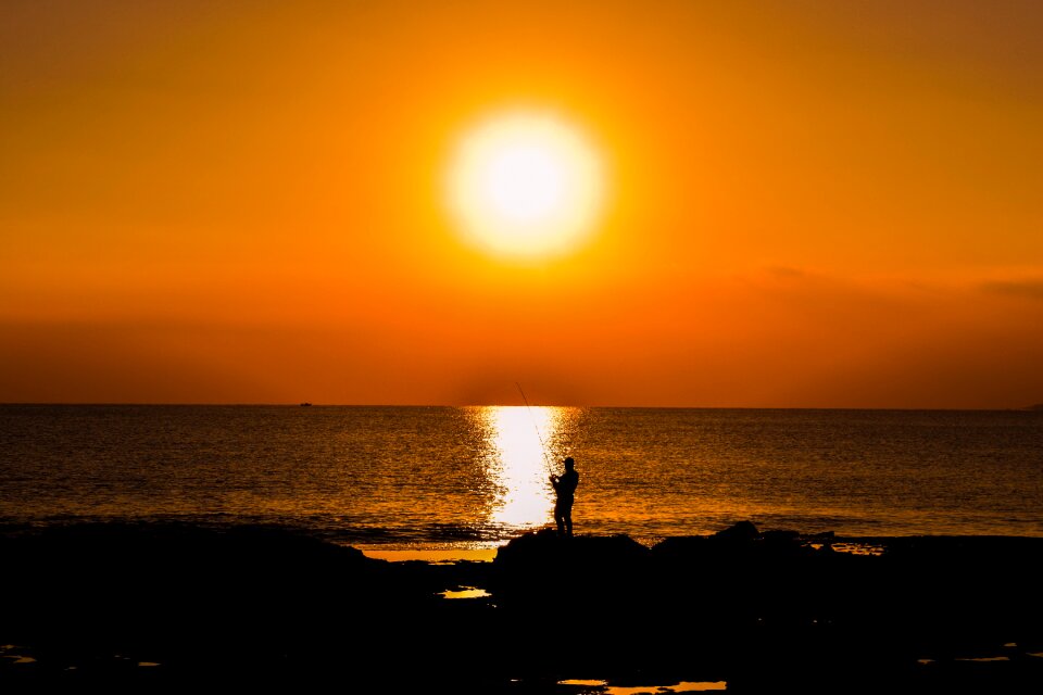 Sea fisherman silhouetted