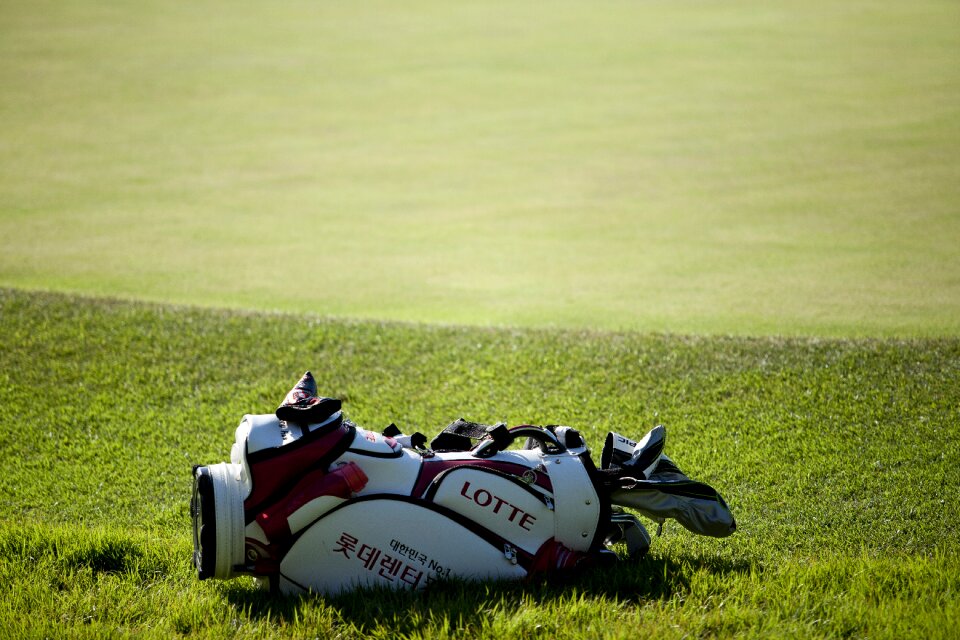 Golf players golf bags grass