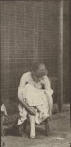 Nude woman sitting and disrobing (rbm-QP301M8-1887-498b~3)