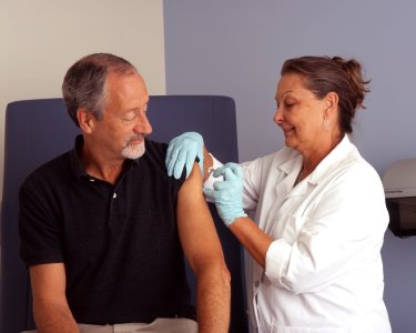 Nurse administers a vaccine (1) photo