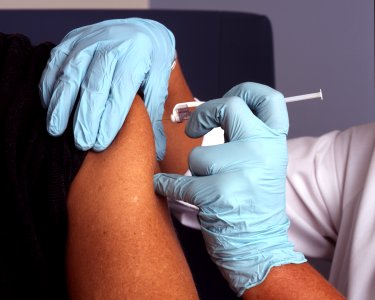 Nurse administers a vaccine photo
