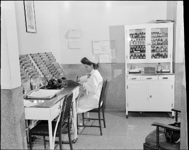 Nurse at chart desk. Clinch Valley Clinic Hospital, Richlands, Tazewell County, Virginia. - NARA - 541098 photo