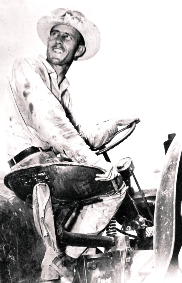 Orville Poddy surveys the wheat fields on his tractor during WWII (19357352684)