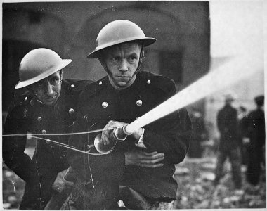 Over 500 firemen and members of the London Auxiliary Fire Fighting Services, including many women, combined in a war... - NARA - 541893